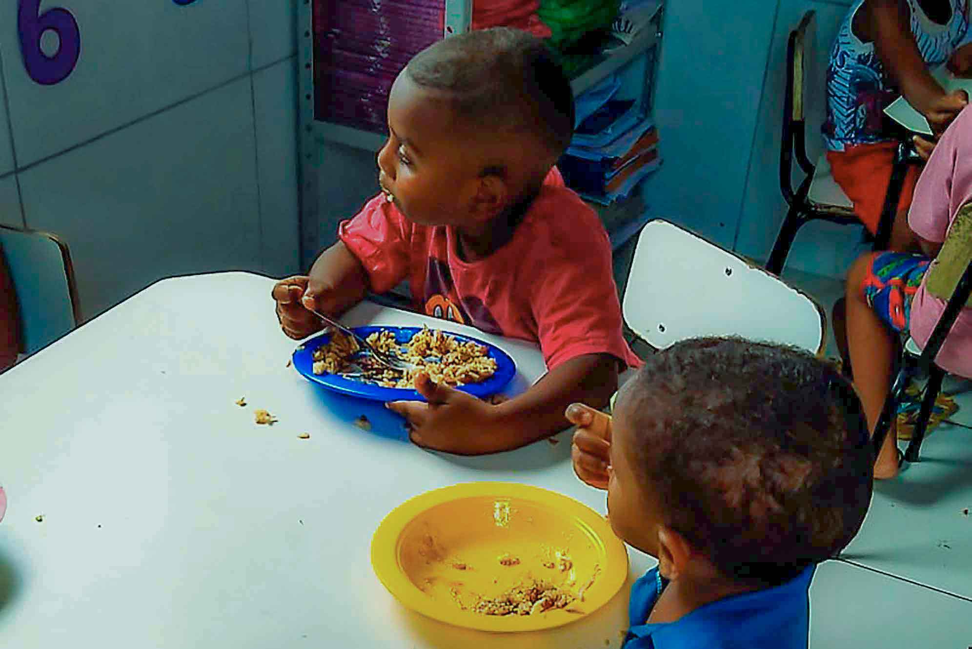 Foto de crianças almoçando